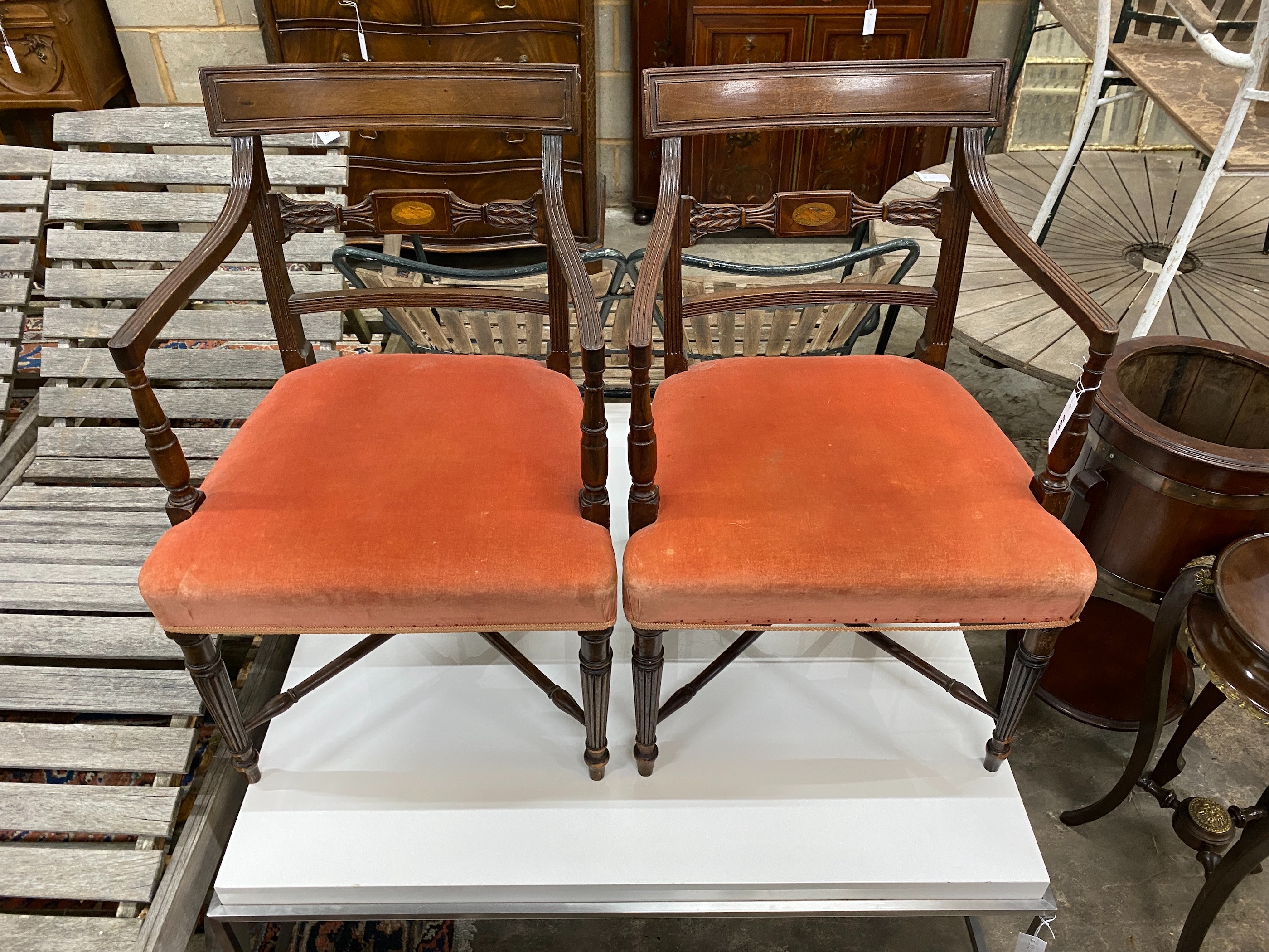 A pair of George III style inlaid mahogany elbow chairs